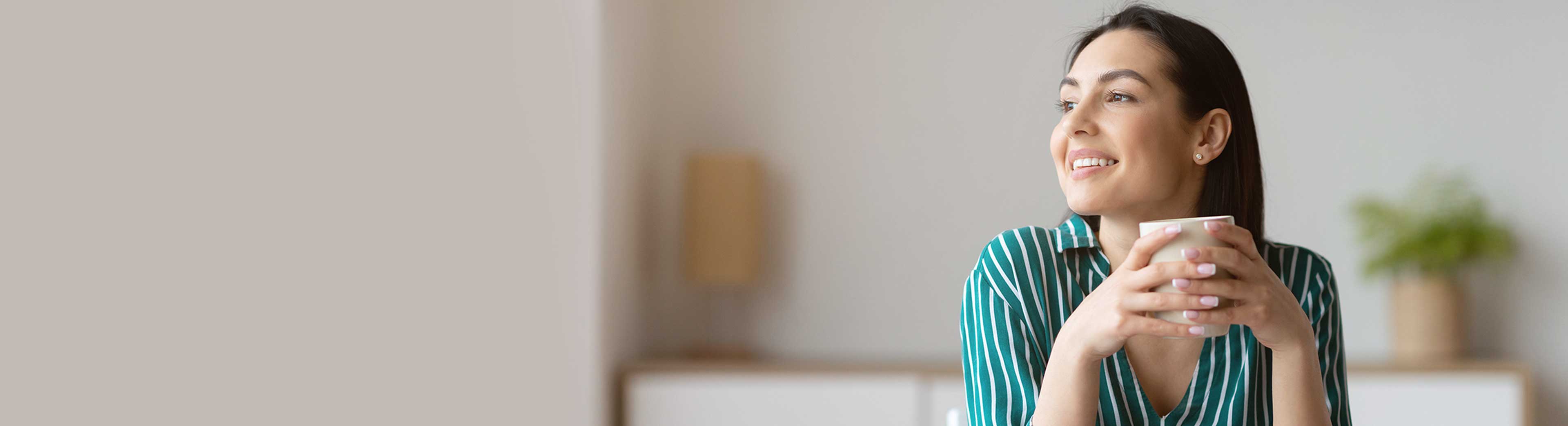 Female office employee with a cup of coffee